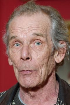 Christopher Fairbank interpreta Grey