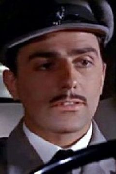 Neville Jason interpreta Hilaire, Wedding Party Guest