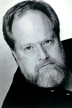 William Hootkins interpreta Barney